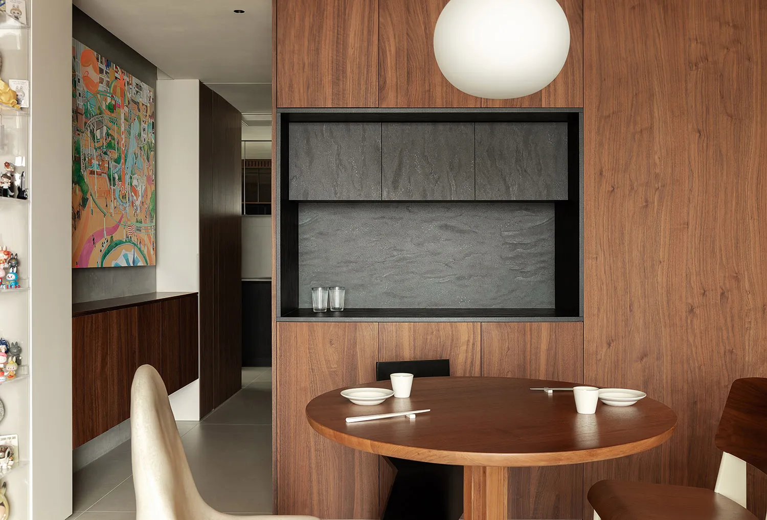 A modern kitchen featuring wooden elements, with a round dining table and chairs.