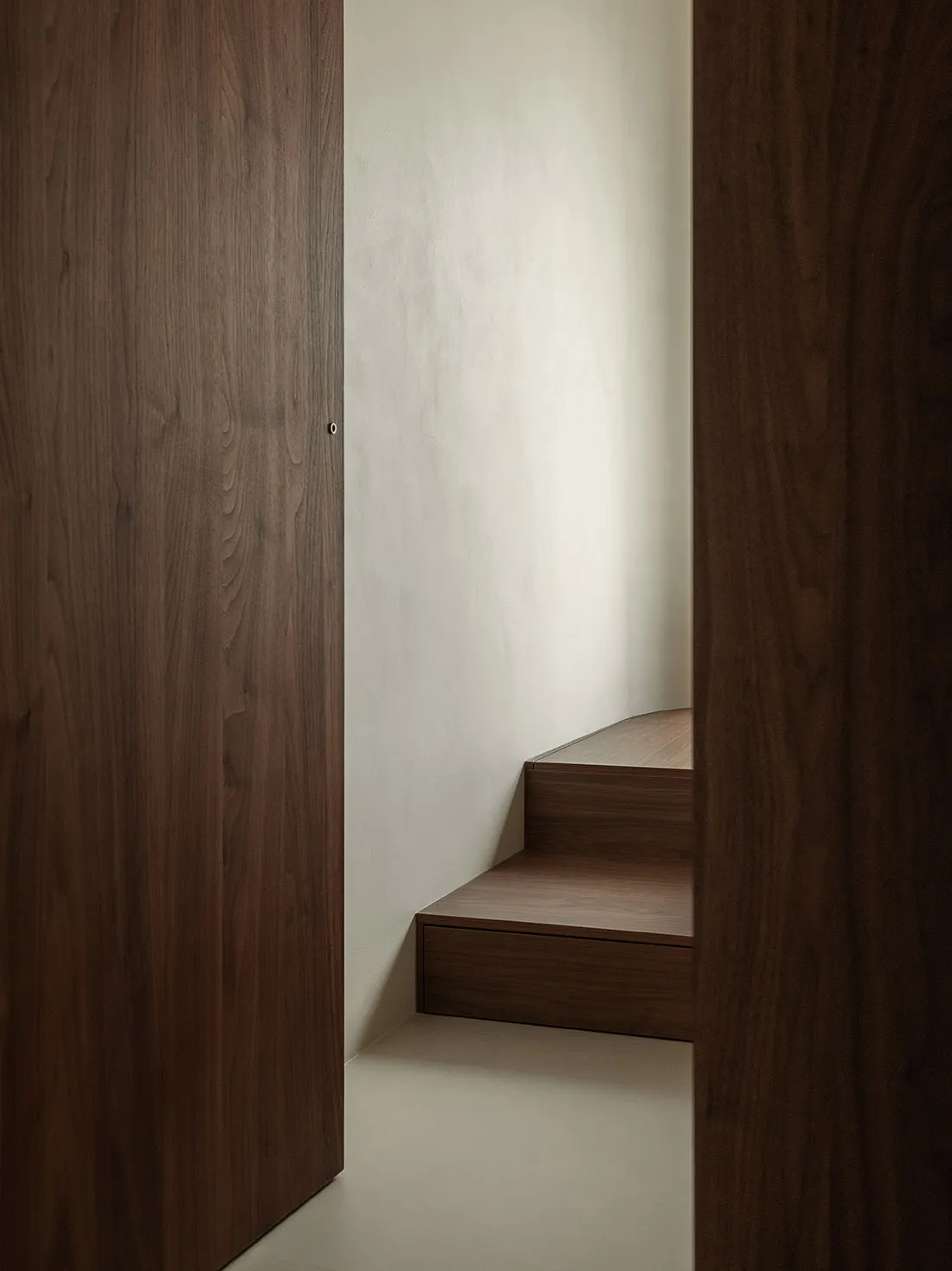 A modern, linear staircase with wooden treads and walls.
