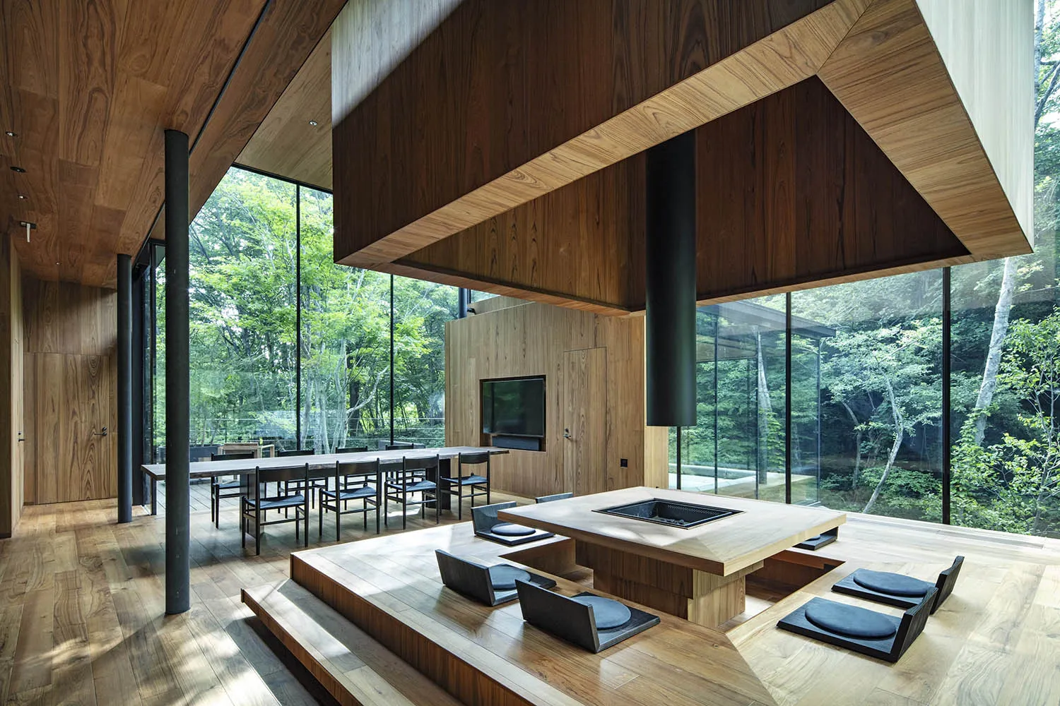 A modern living room with wooden furniture and a central fireplace.