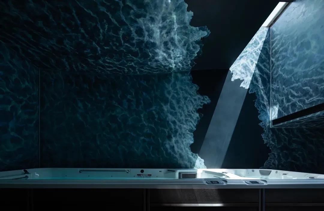 Concrete bathtub with wave-like water effect in the background