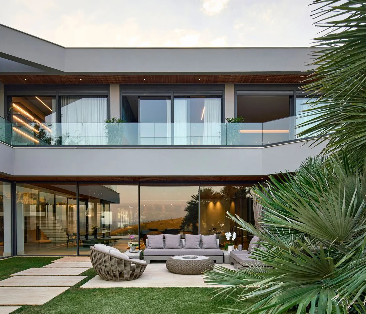 A modern residential patio featuring a concrete floor and comfortable seating arrangements.