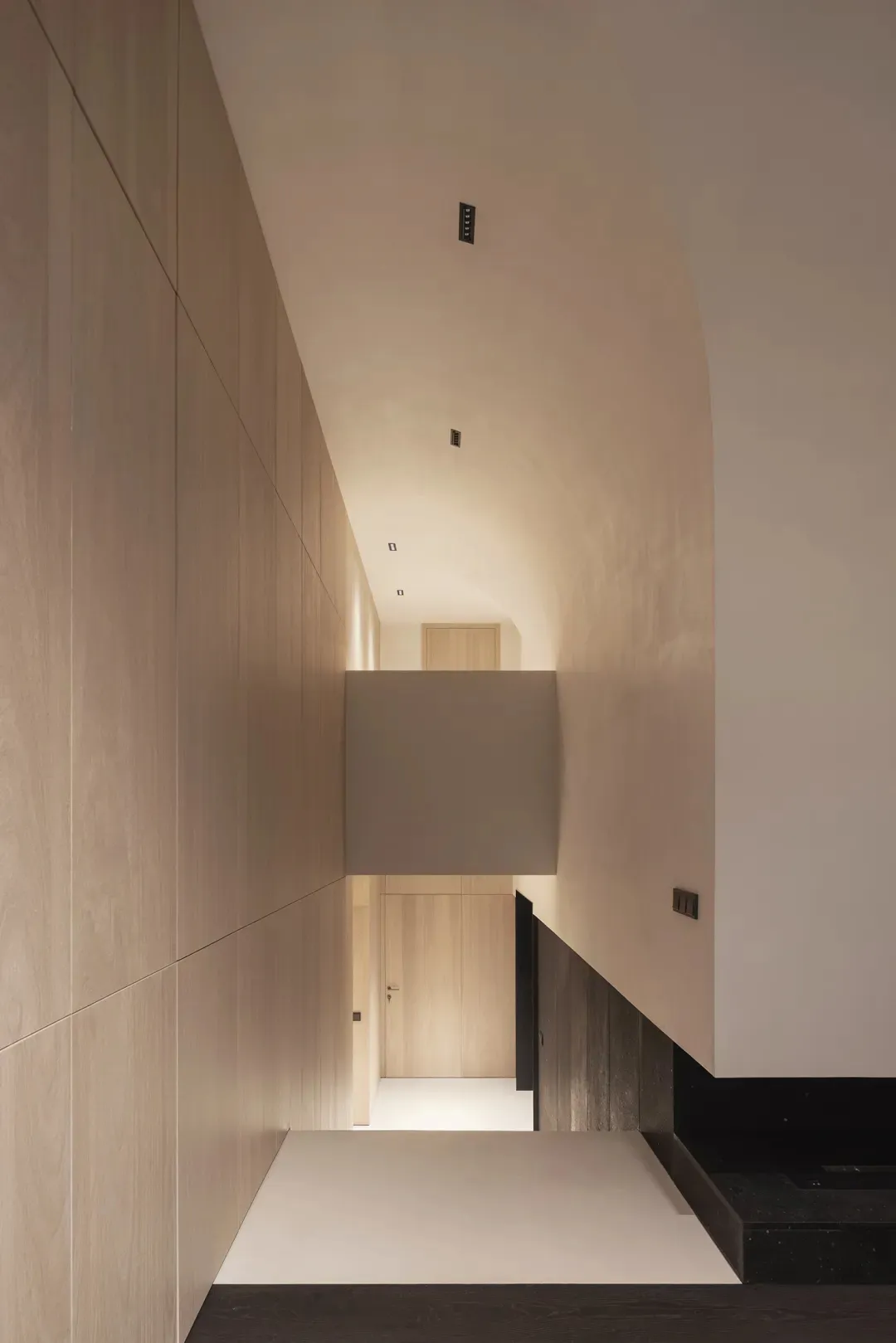Modern interior design featuring a hallway with minimalist lighting and wood materials.