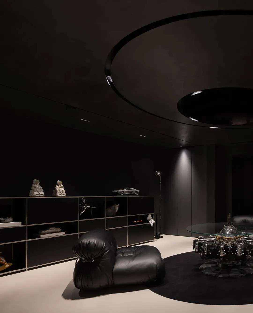 Modern living room featuring sleek, black metallic furniture and minimalistic decor.