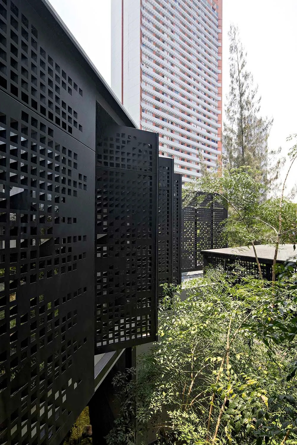 Urban rooftop with modern black perforated metal grid for greenery