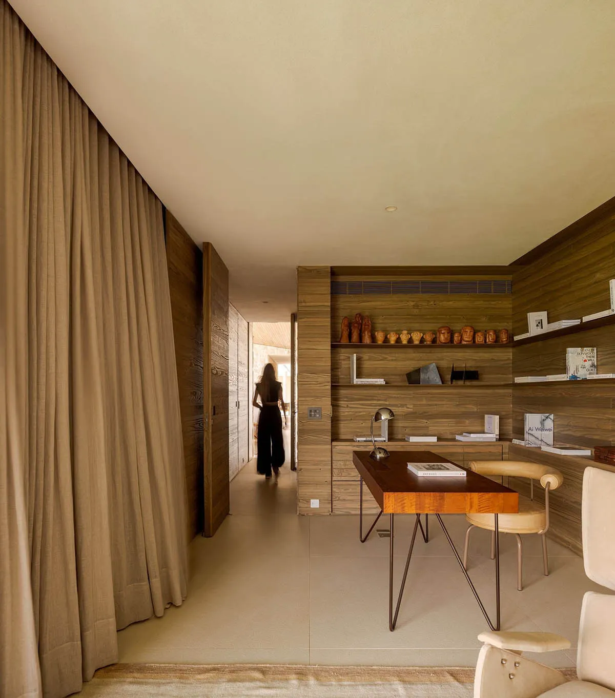 A modern home office featuring wooden walls and a minimalist design.