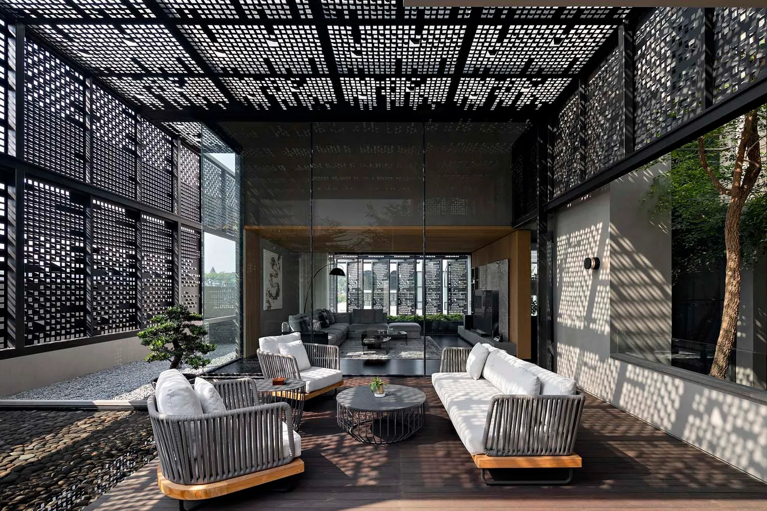 A modern living room with concrete and glass walls and furnishings.