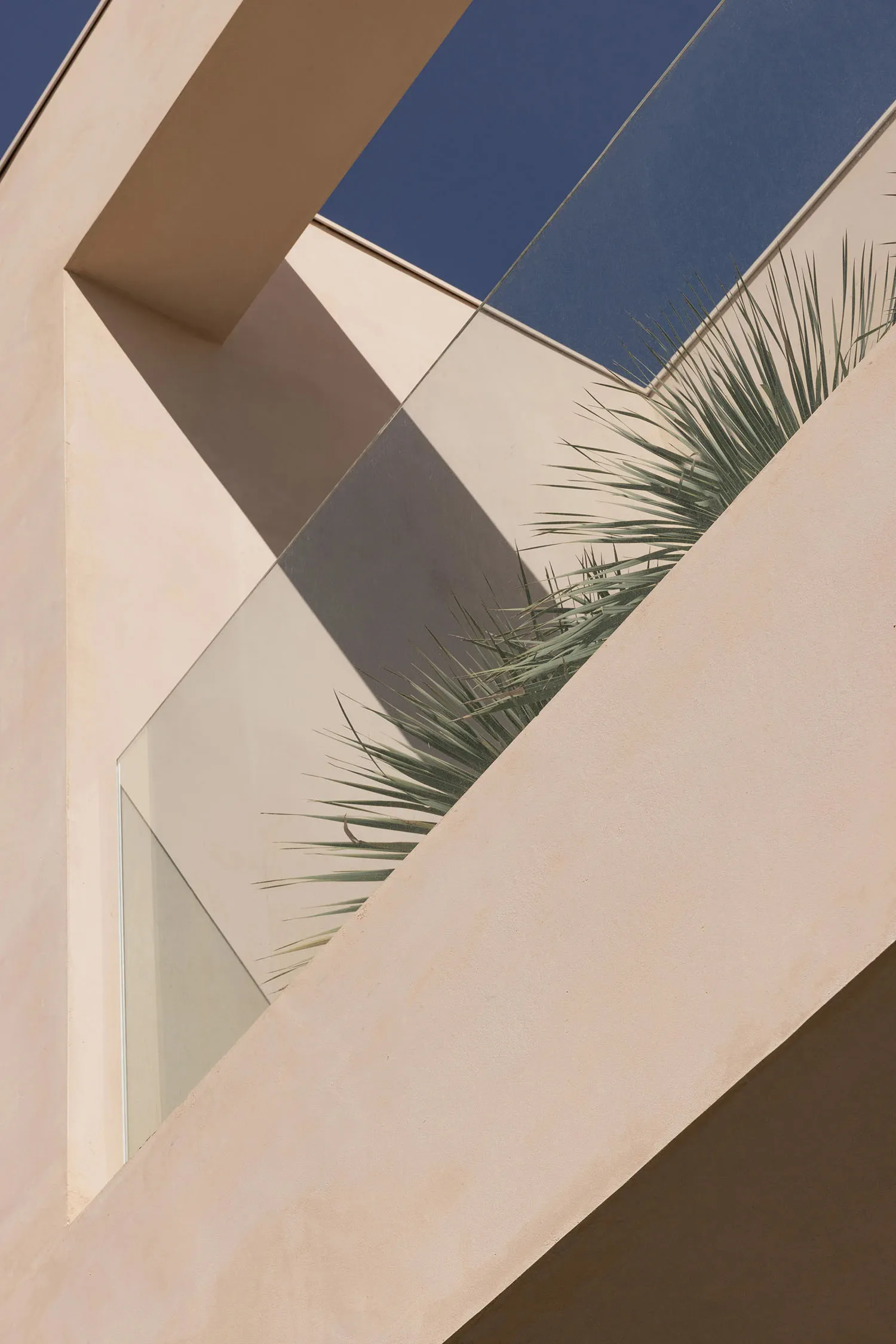 Modern building exterior featuring glass and concrete materials.
