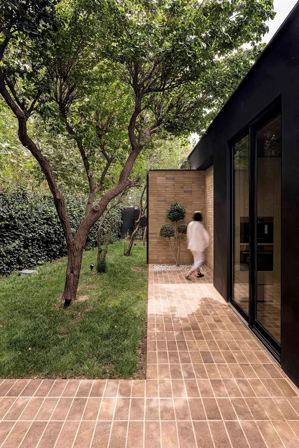 A modern exterior featuring brick, glass, and concrete materials.