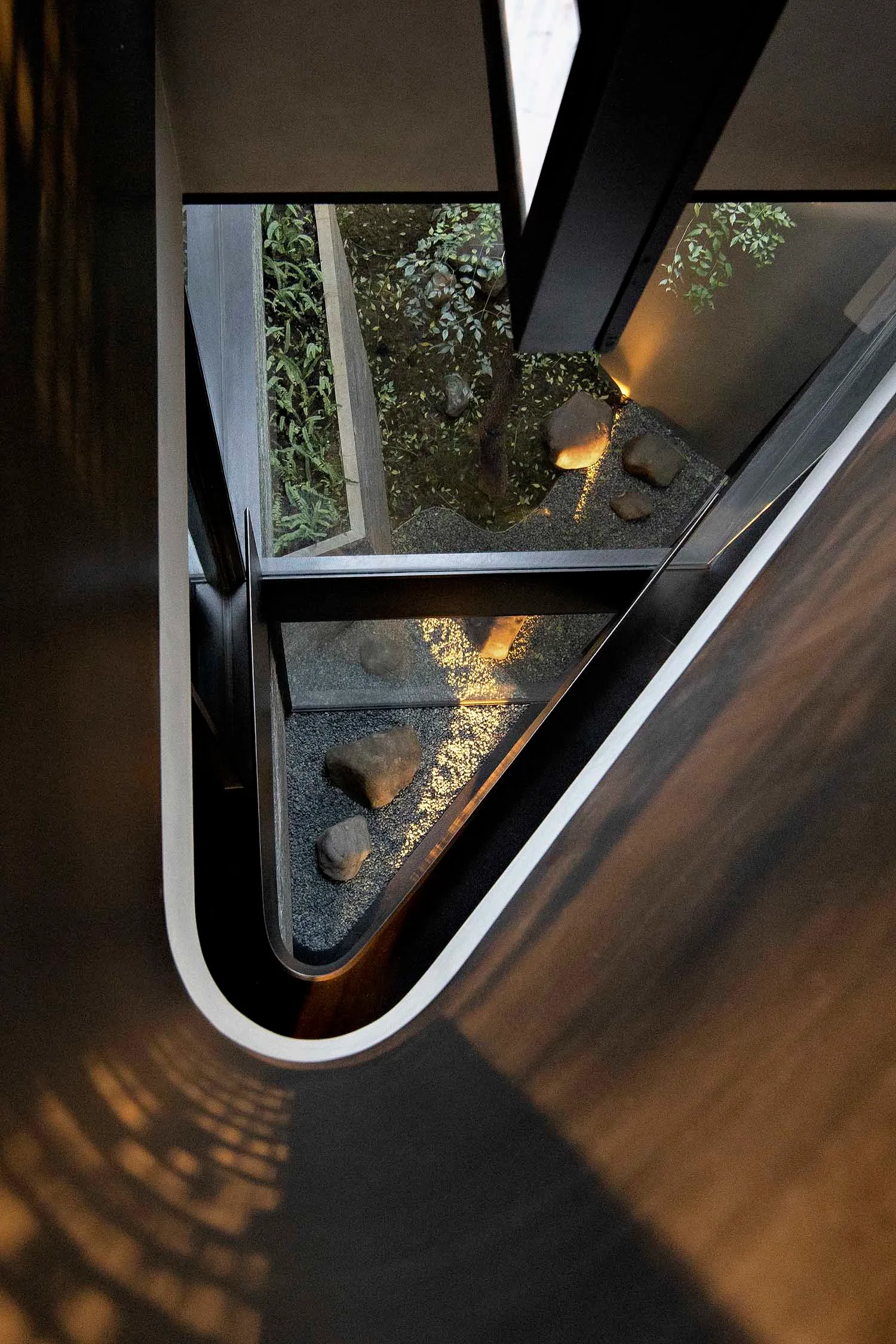 A modern concrete garden with glass walls.