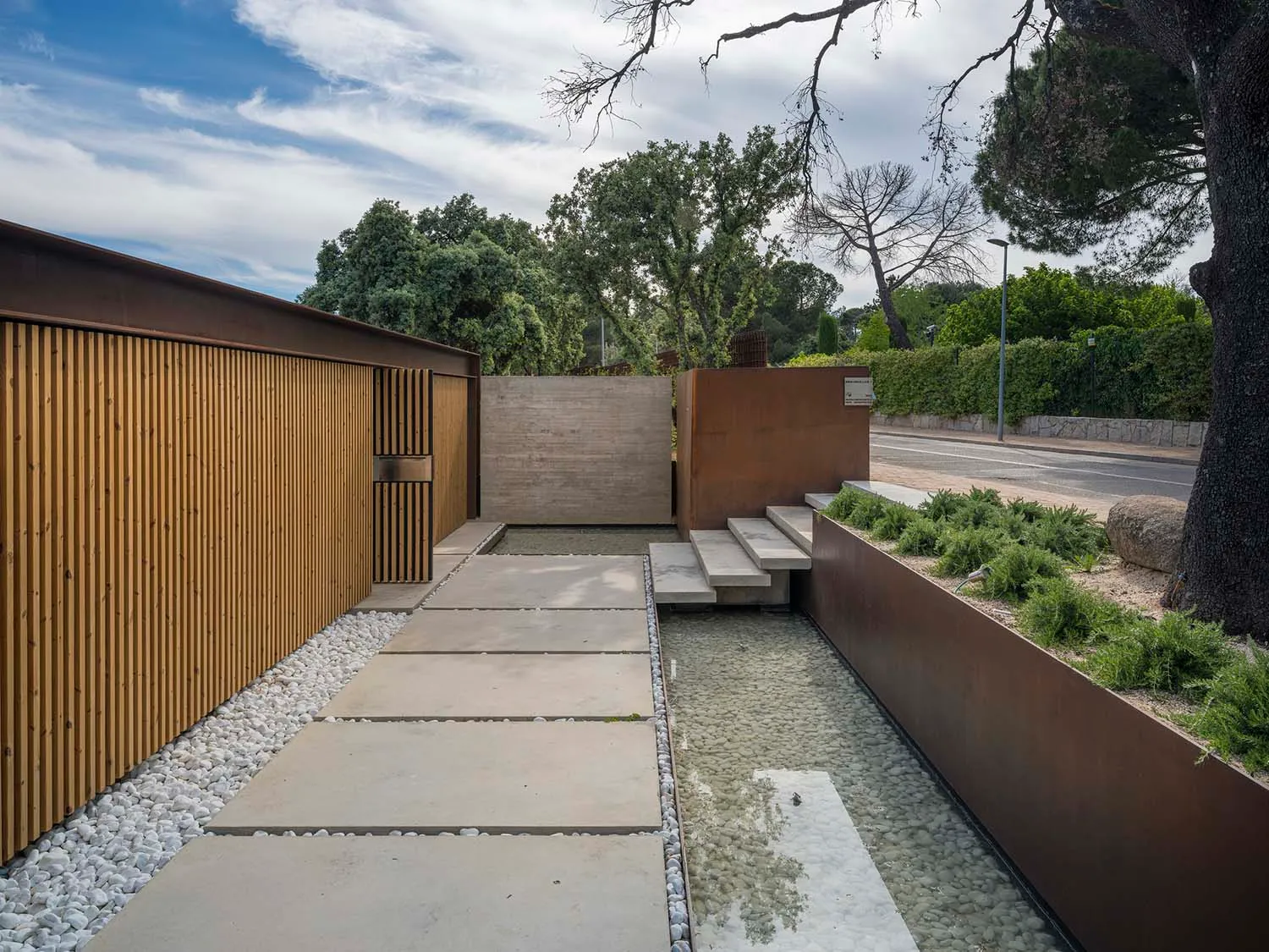 A modern landscape design featuring concrete elements and a minimalist approach.