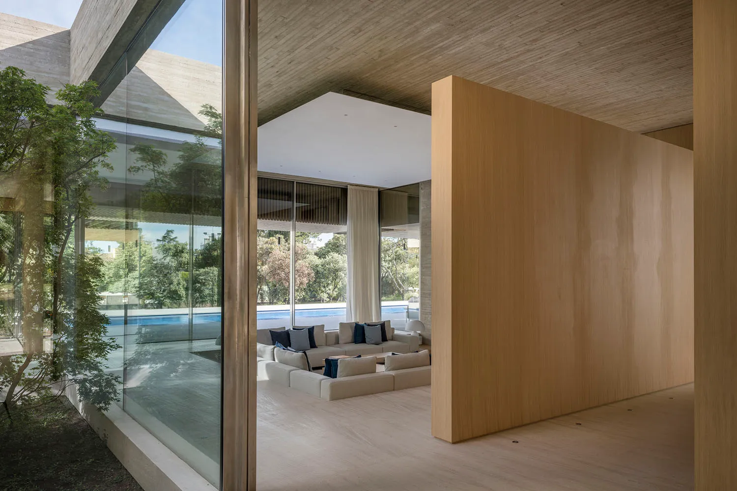 Modern living room featuring concrete and wooden elements.