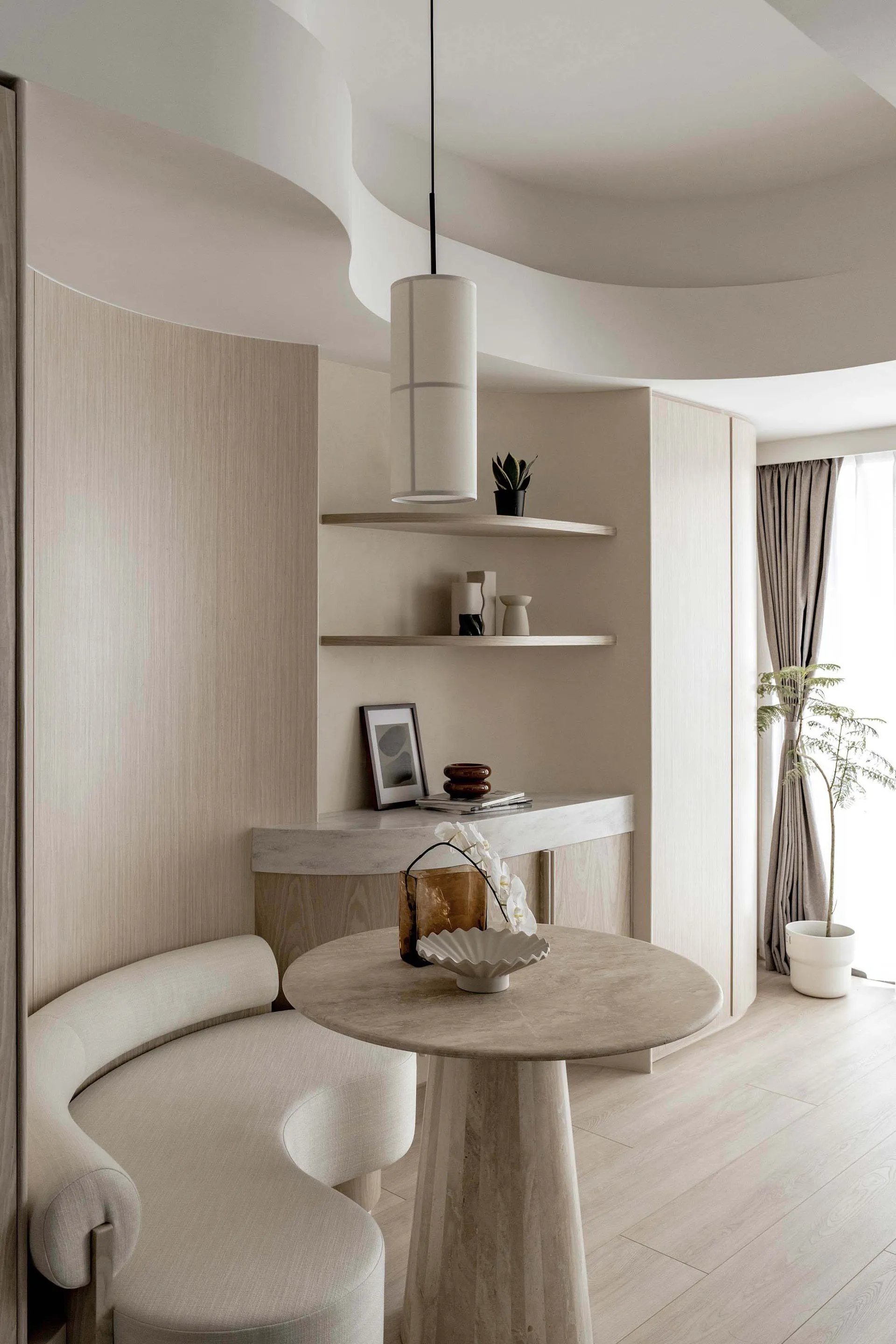A minimalist living room featuring wooden furniture and shelves.