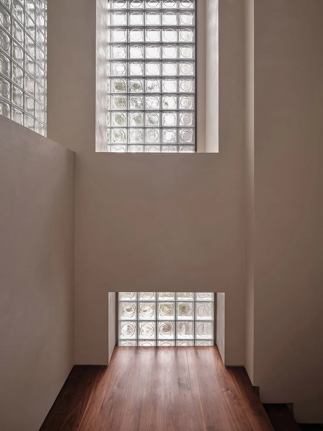 A rendering of an interior space featuring glass block walls.