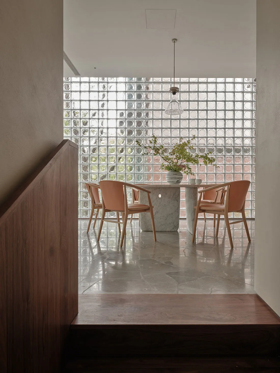 A modern dining room with white marble table and chairs.