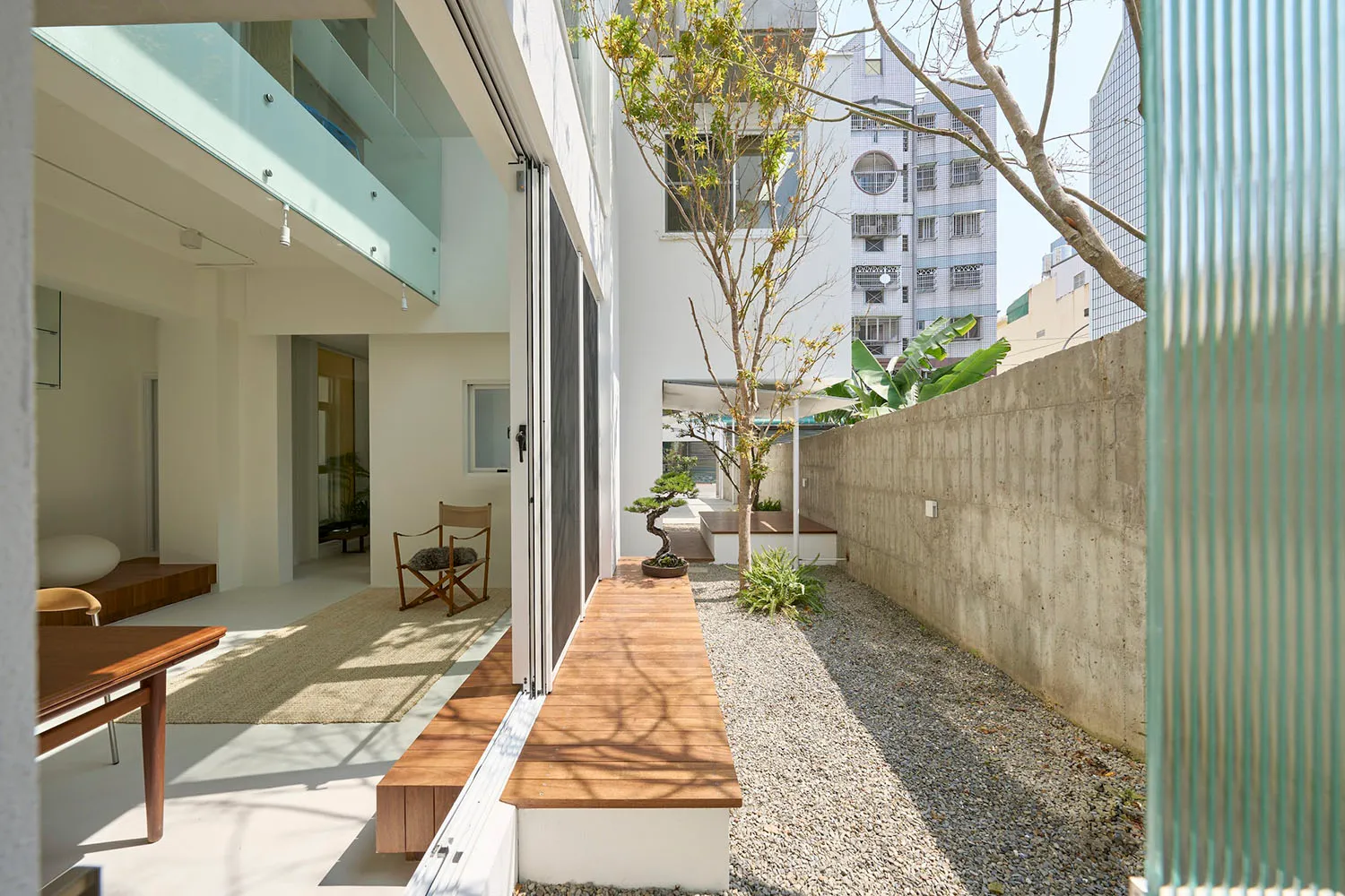 Modern residential space featuring wood and concrete materials.