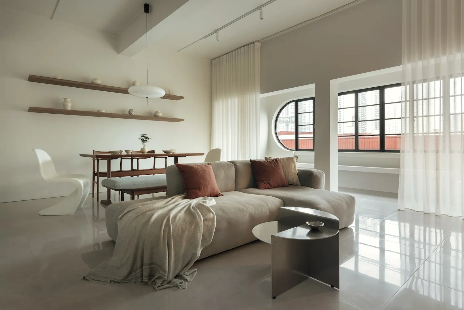 A modern living room with neutral-toned furniture and a minimalist design.