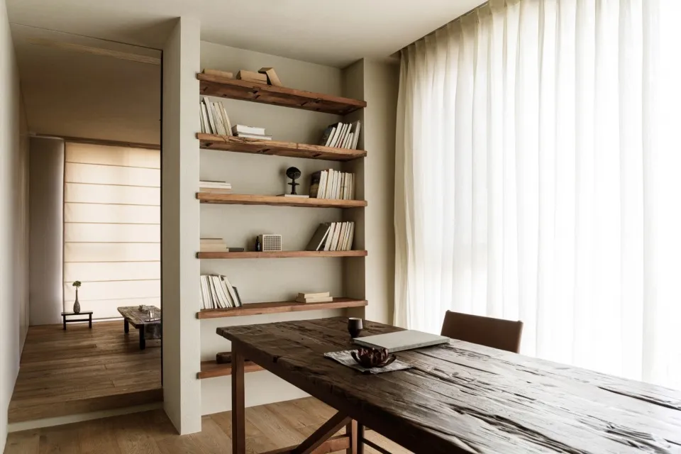 A rustic home office featuring industrial-style shelving made of reclaimed wood.