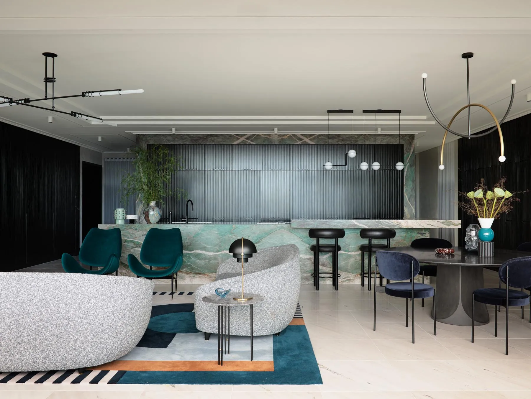 A modern living room with sleek marble finishes and contemporary furniture.