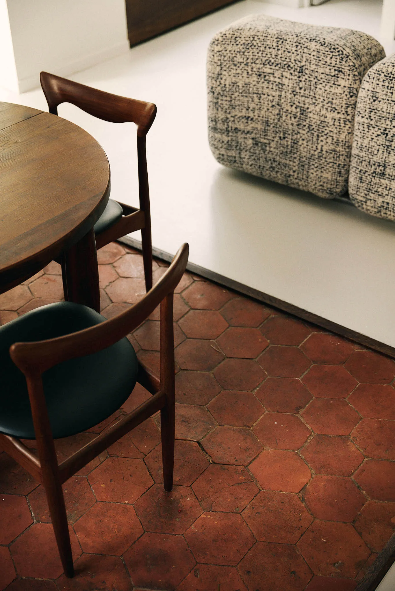 Modern residential interior with wood furniture and fabric seating.