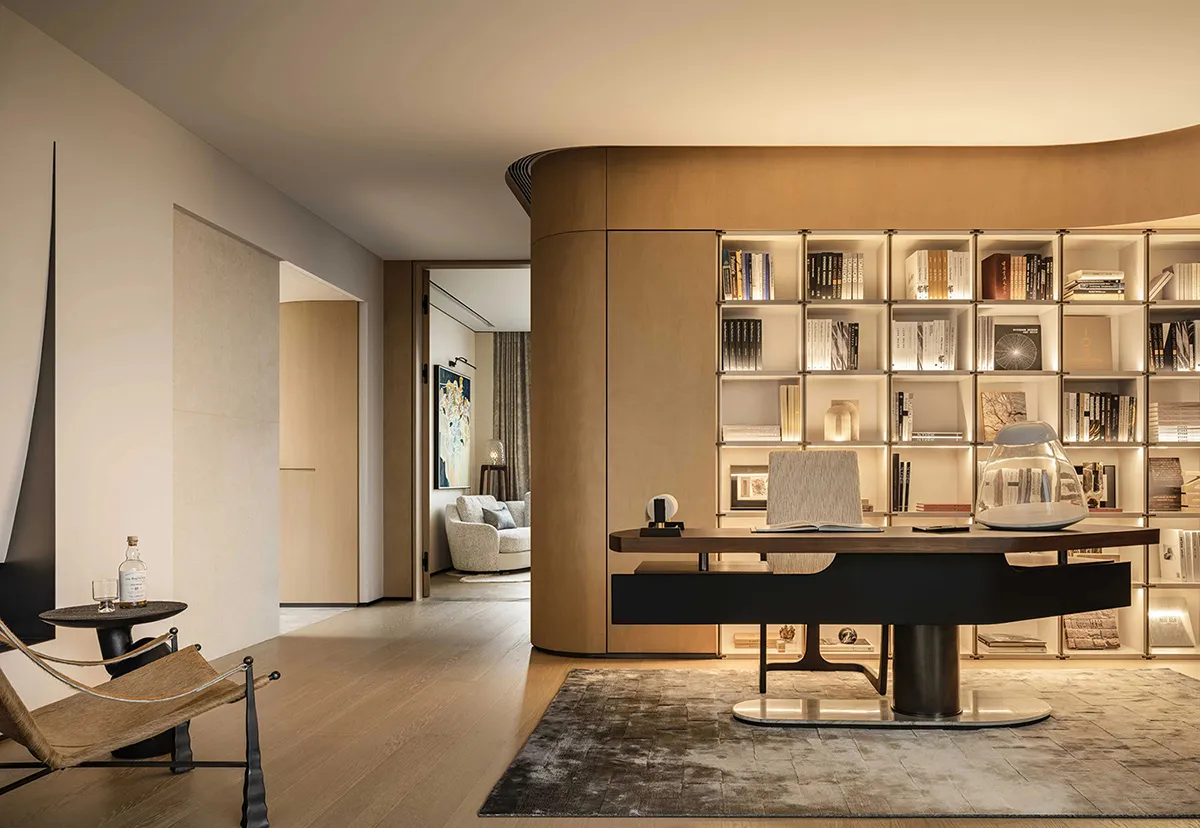 A modern home office featuring a wooden wall panel with built-in lighting.