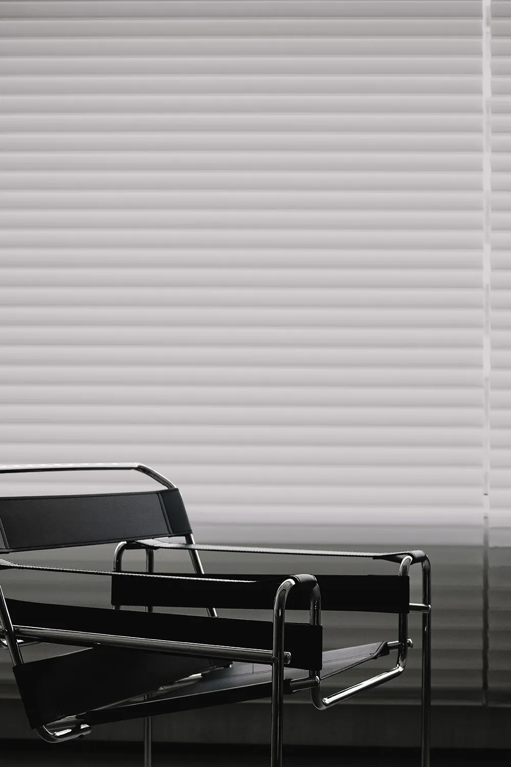 Minimalist black leather chair with chrome frame.