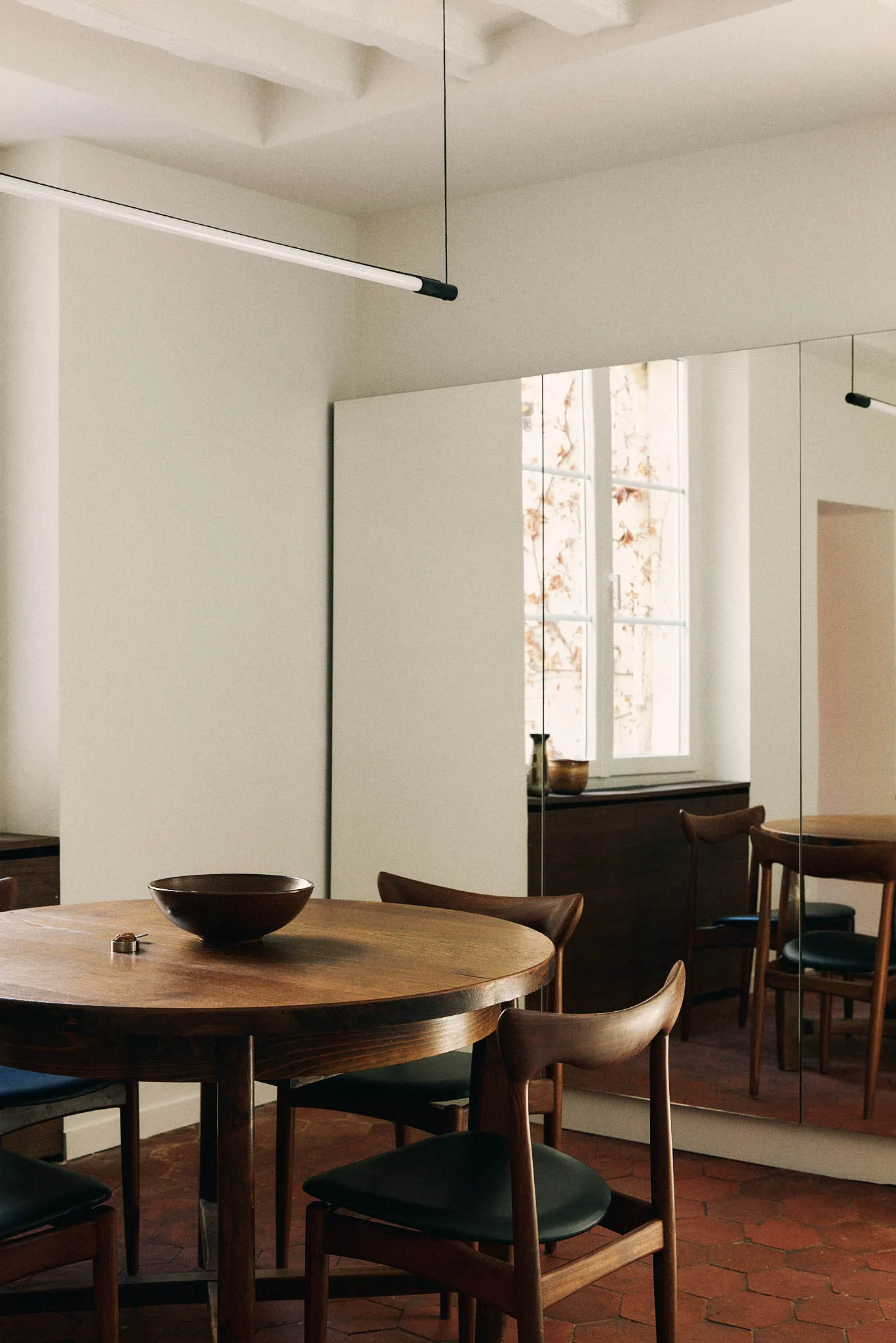 Modern minimalist kitchen featuring wooden furniture and a simple, clean design.