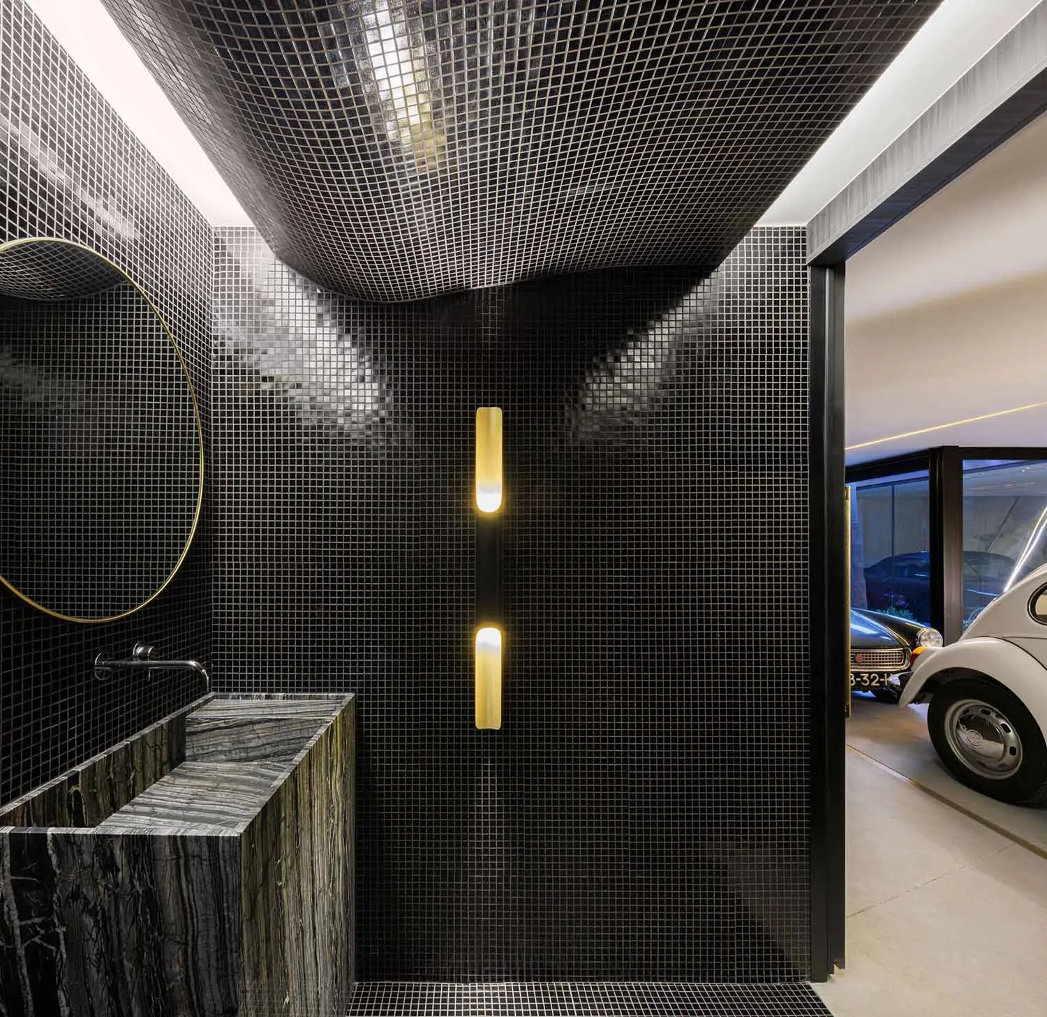 Modern bathroom with black metallic tiles and a minimalist design.