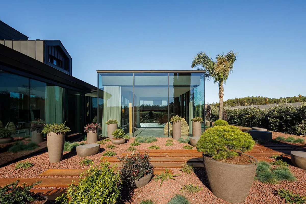 Contemporary residential exterior featuring large glass panels.