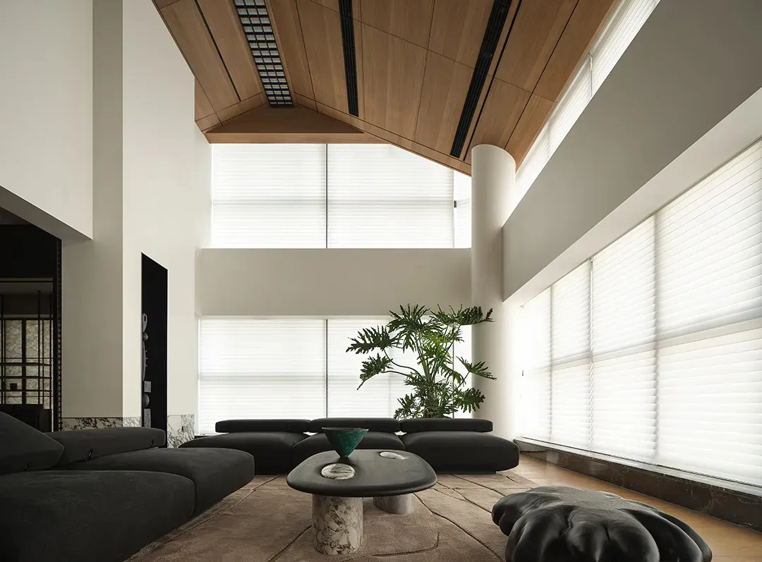 A minimalist living room with natural wood accents, featuring large windows and a modern coffee table