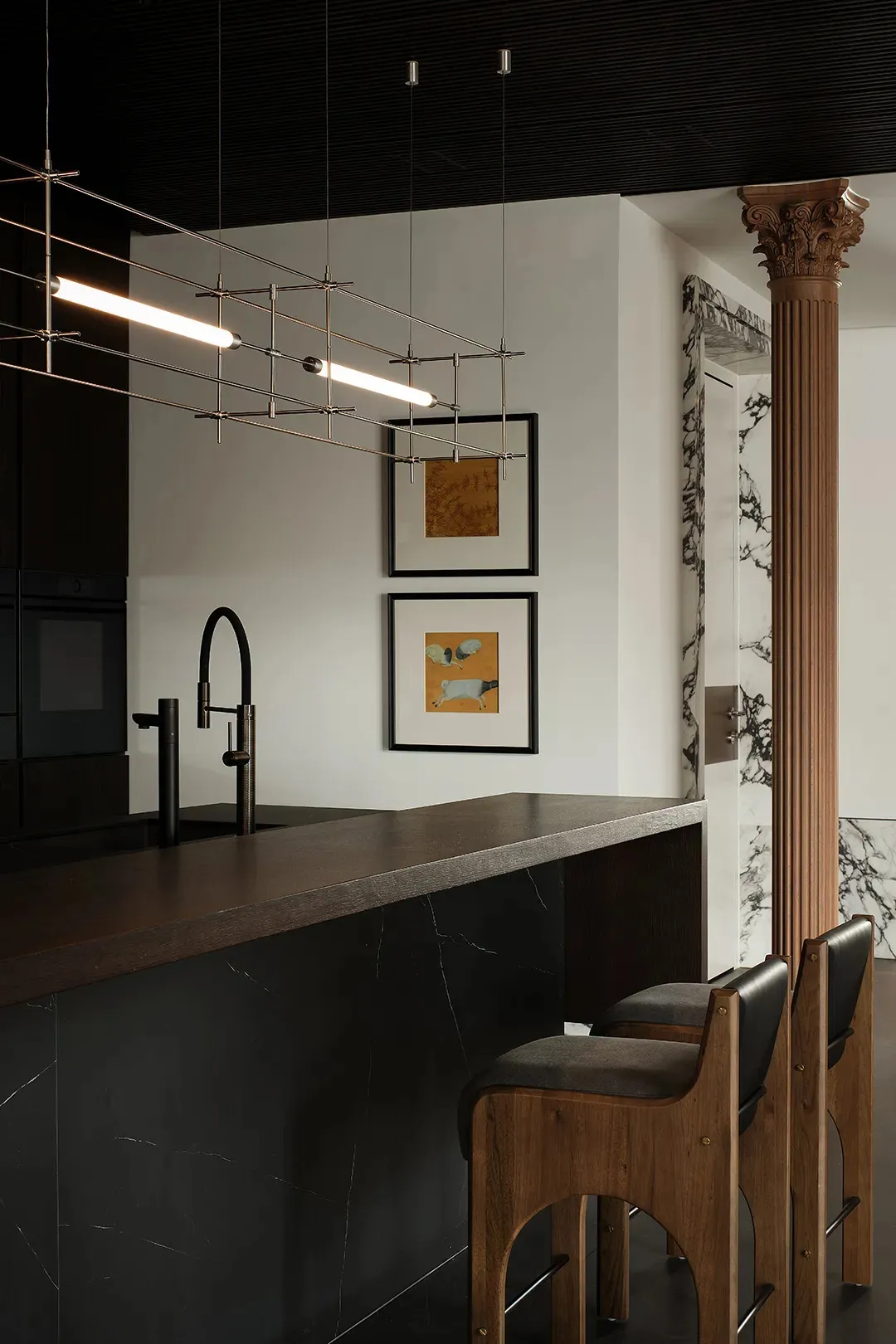 A modern kitchen with a dark marble countertop and minimalist design.