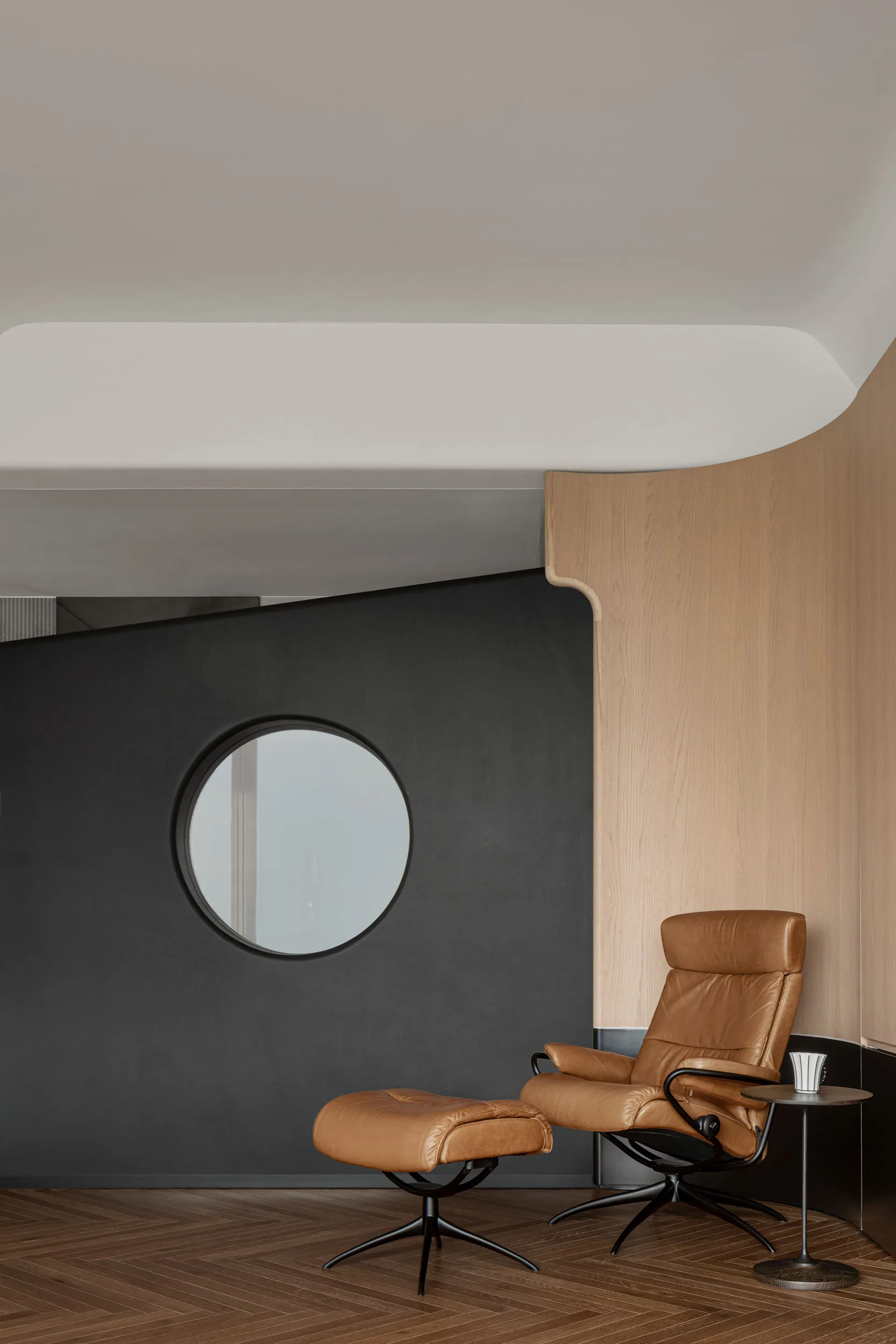 A modern living room with a comfortable brown leather recliner and matching ottoman