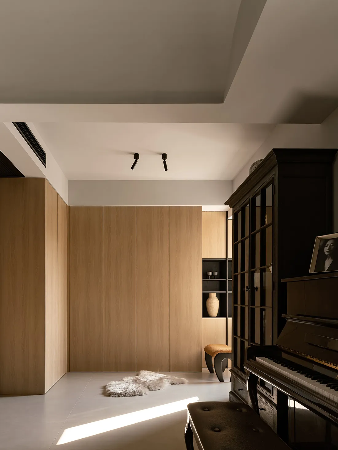A modern music room featuring wood-paneled walls, a grand piano, and a cozy atmosphere.