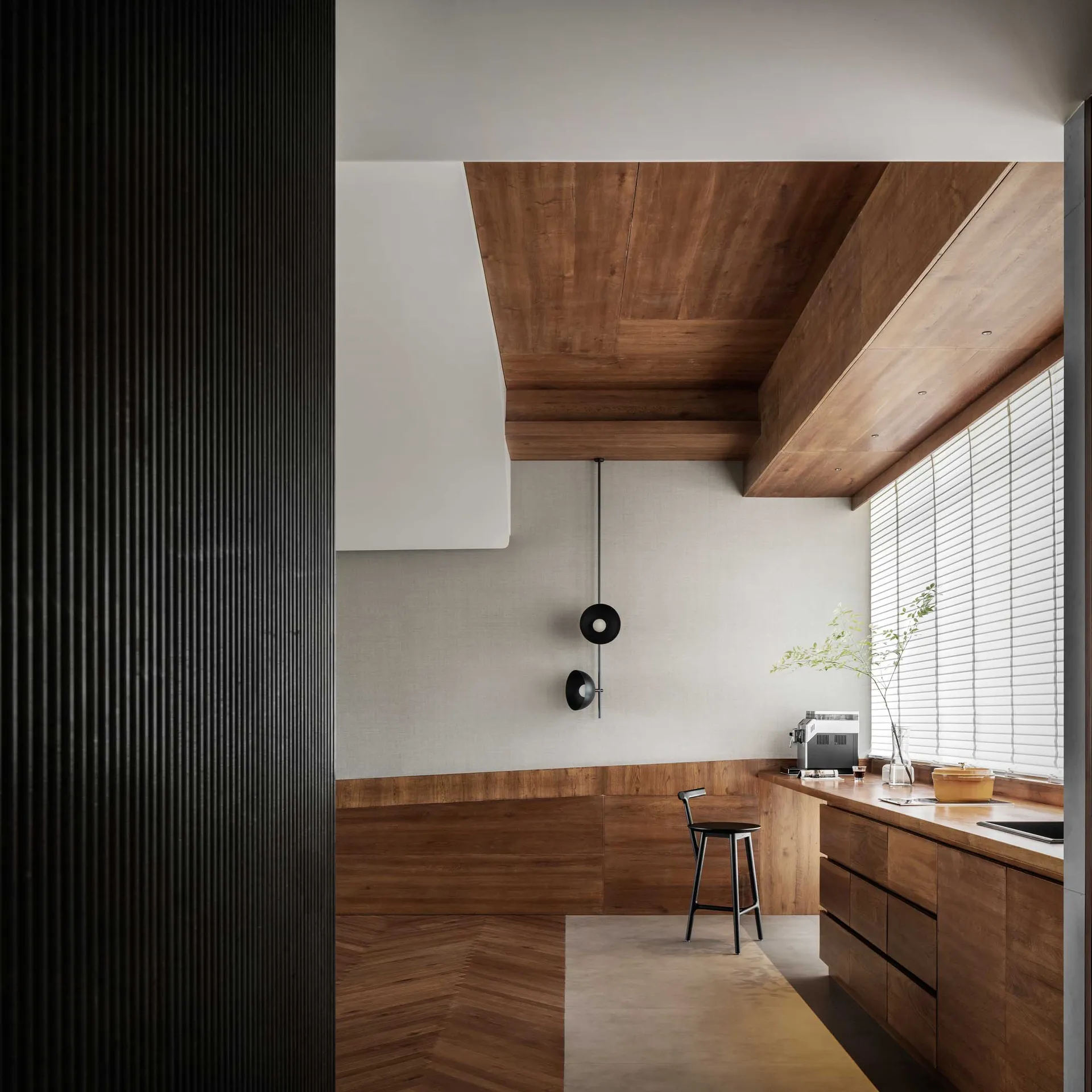 A modern residential kitchen designed with wood materials and minimalist design.