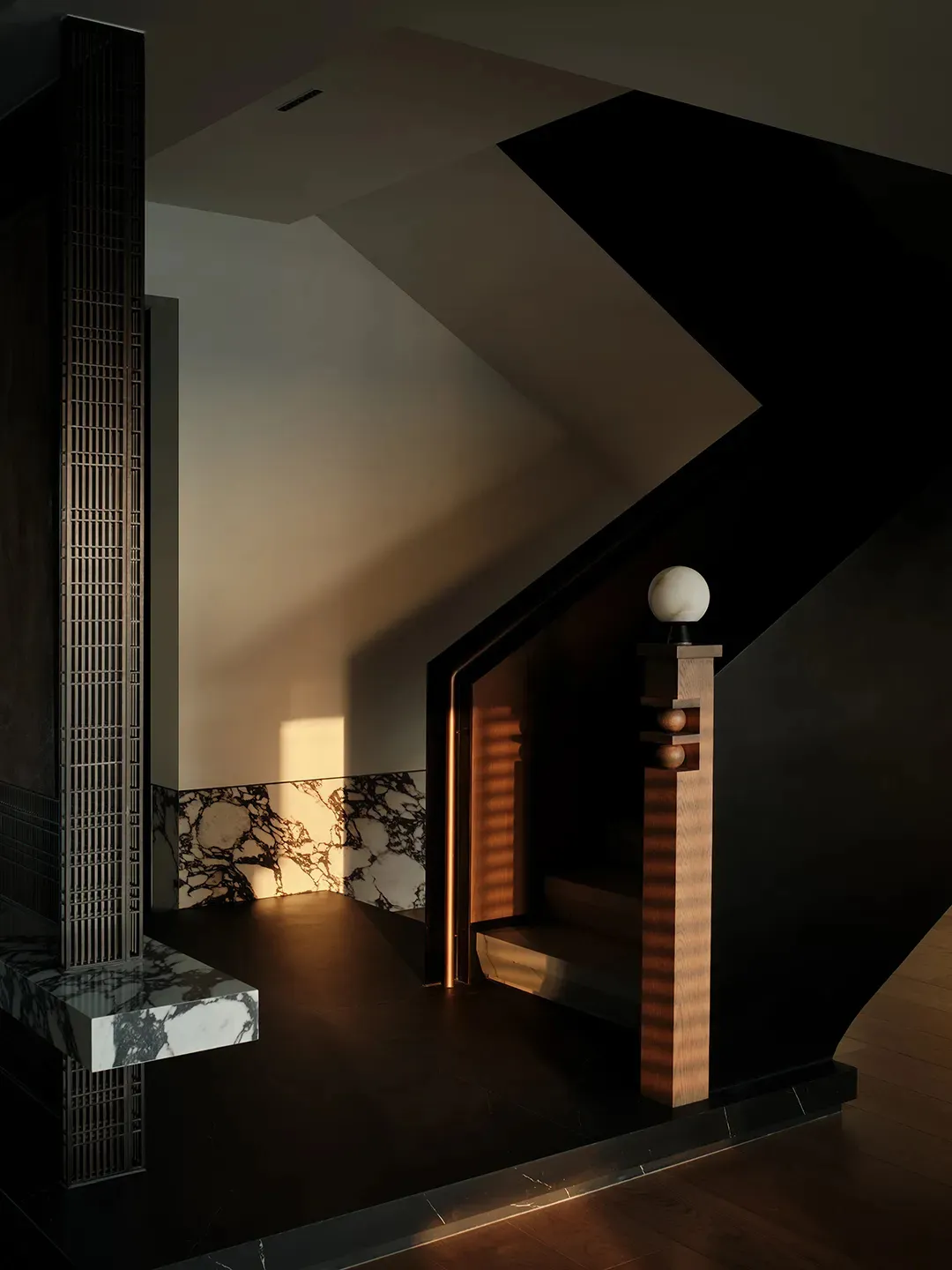 Modern staircase with marble flooring, wood accents, and intricate metalwork.