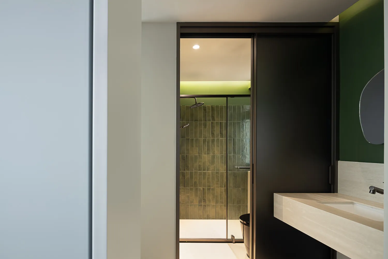 Modern bathroom featuring glass shower enclosure and tile walls