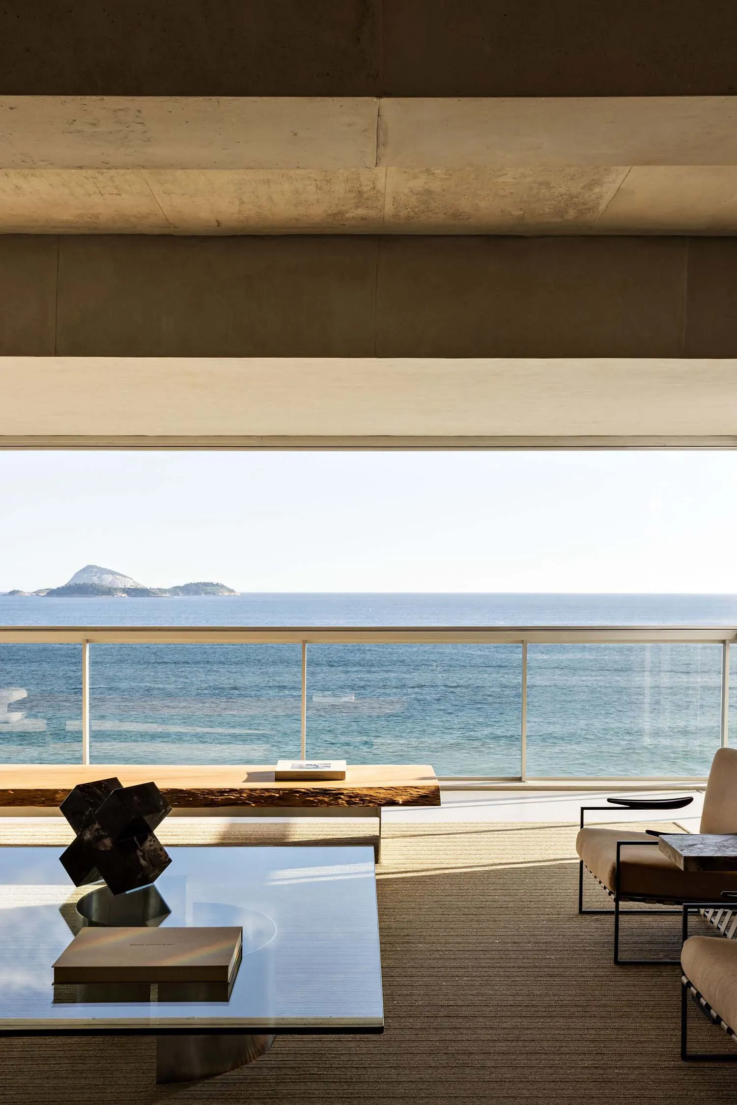 Modern minimalist living space featuring concrete, glass, and marble materials.