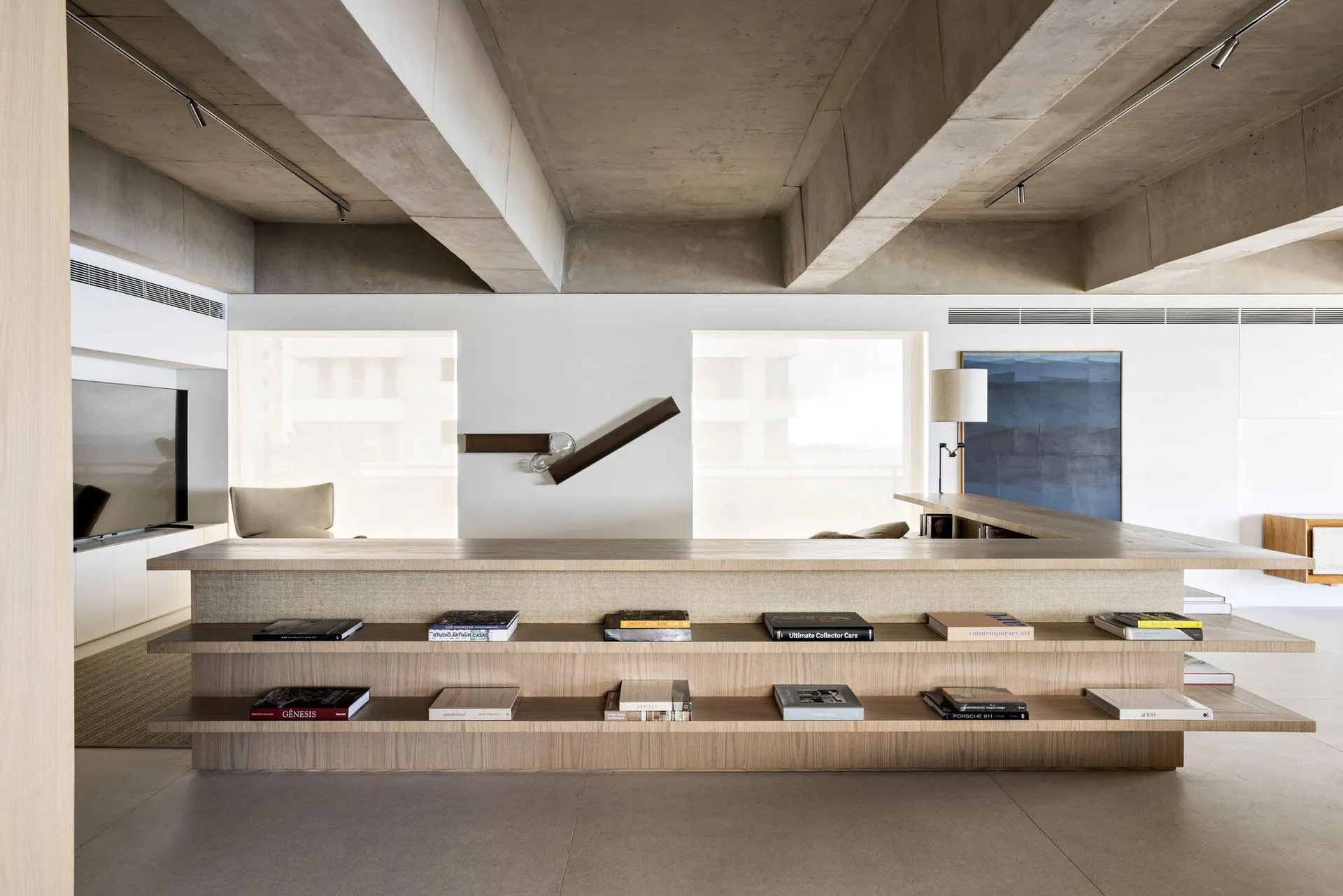 Modern living room featuring concrete, wood, and glass materials