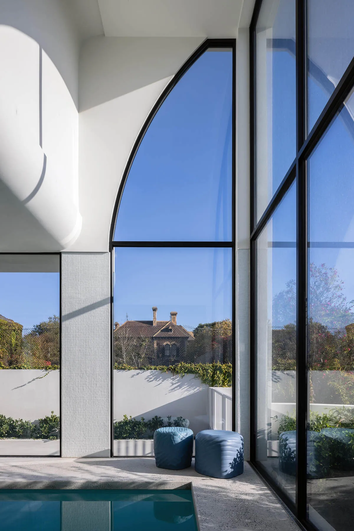 A modern villa with large glass windows and a sleek design.