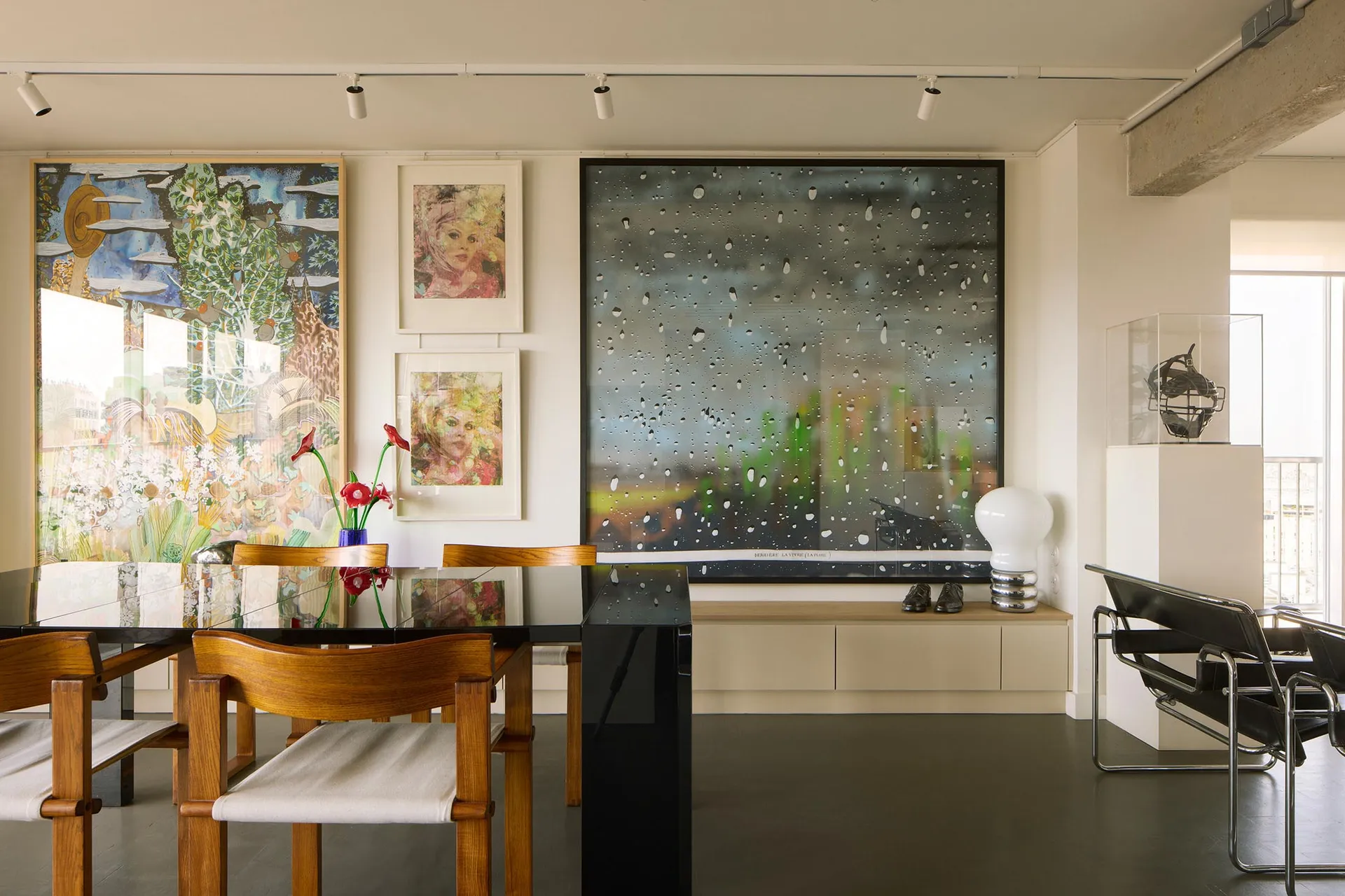 A modern minimalist interior featuring artwork in a residential setting.
