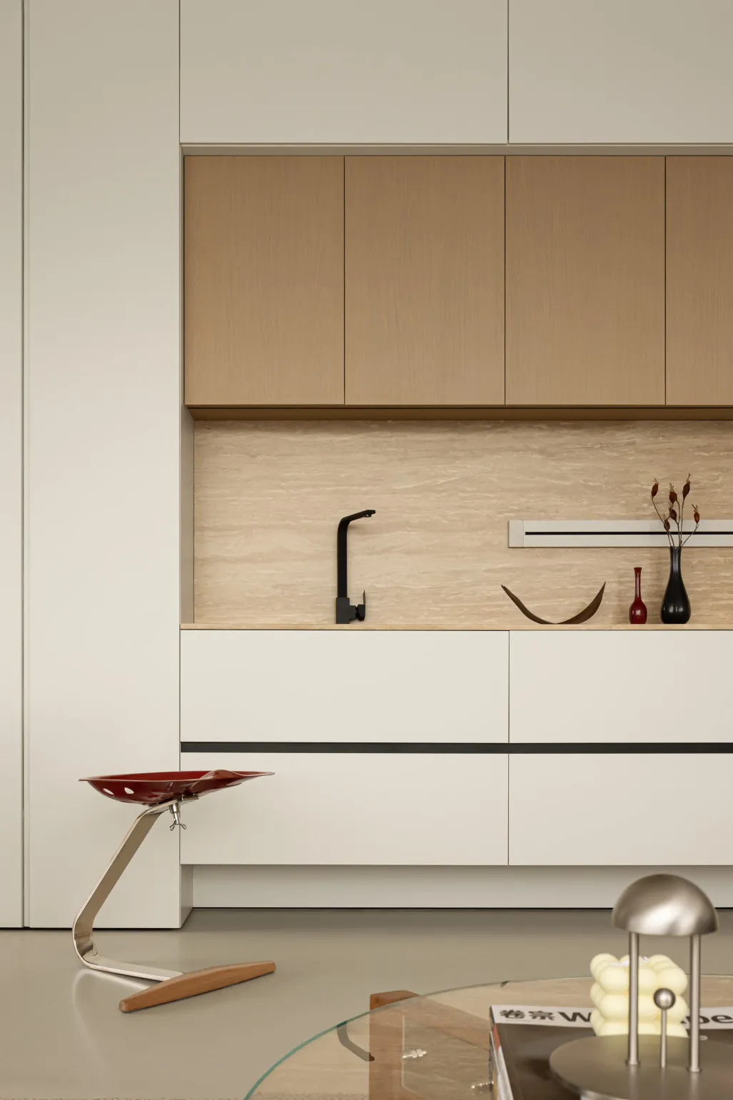 A modern, minimalist kitchen featuring wooden cabinets and marble countertops.