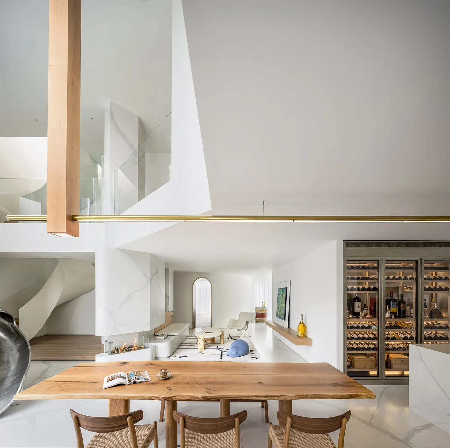 Modern minimalist living space with white walls, wooden furniture, and contemporary decor.