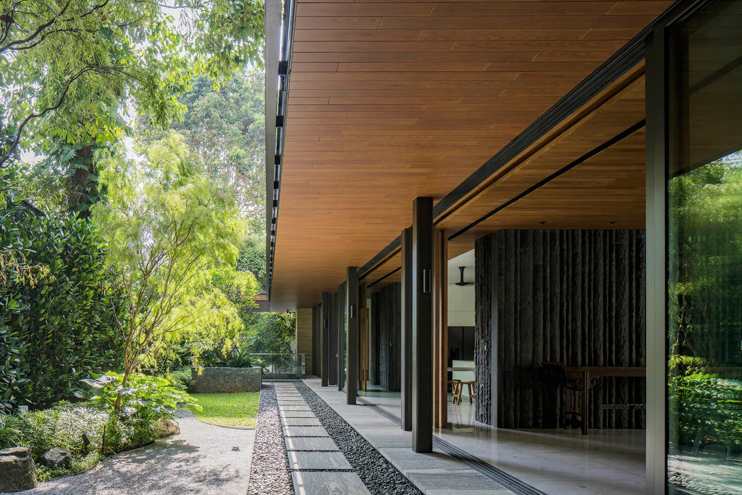 Modern home entrance featuring glass doors and a wooden ceiling
