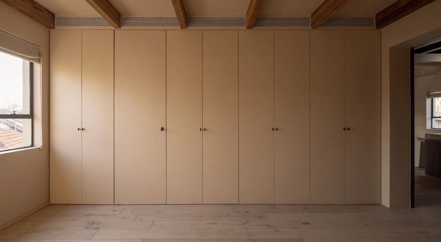 A minimalist interior design featuring a closet with wooden paneling.