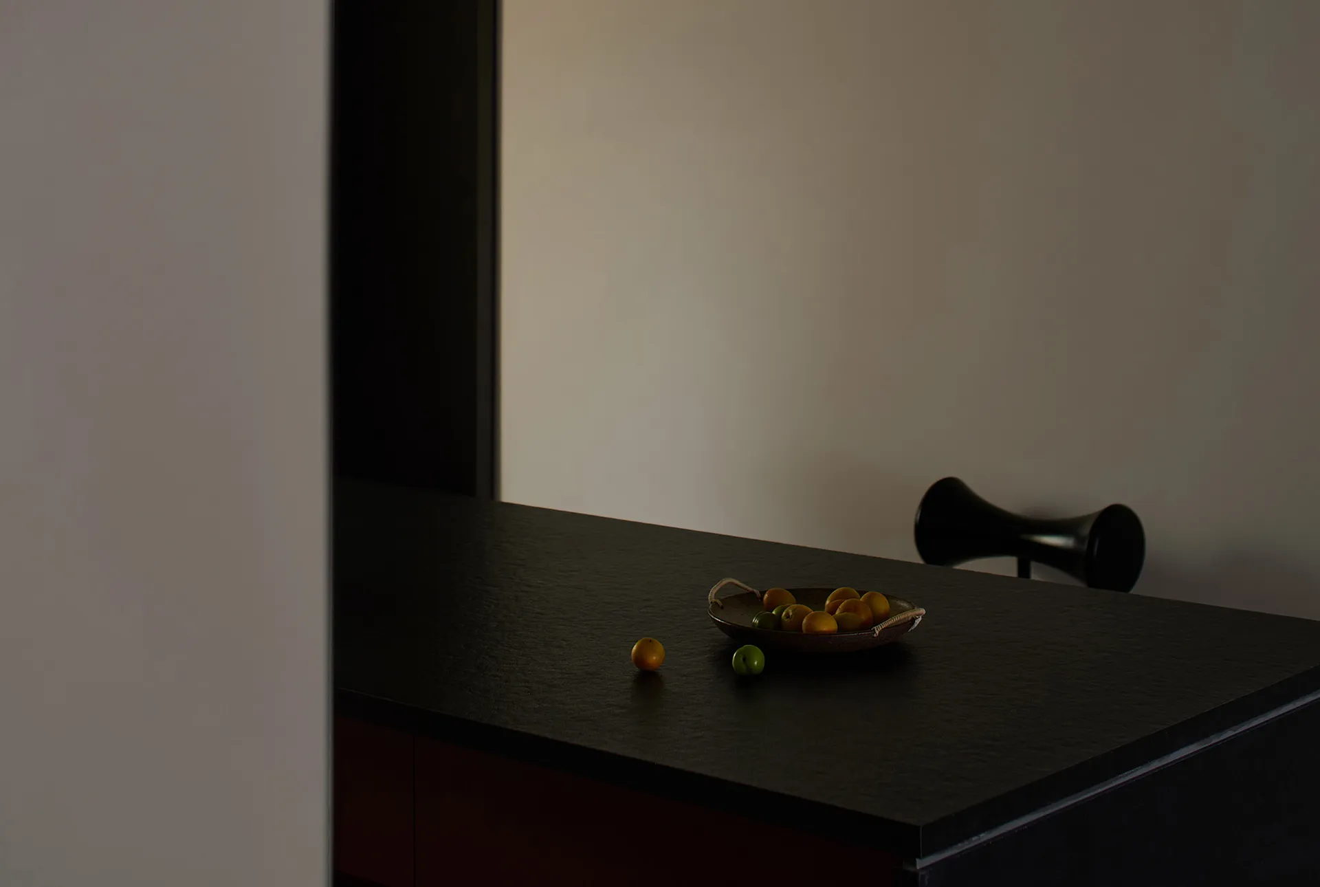 A modern kitchen with stone countertops and minimalist design features.