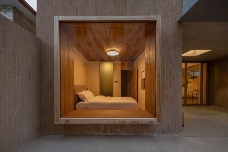 Modern minimalist bedroom with a floating platform bed made of wood, featuring a sleek design with concealed lighting and a m