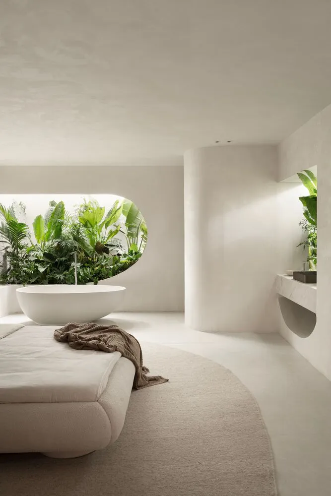 Modern minimalist bathroom with concrete walls, white fixtures, and green plants