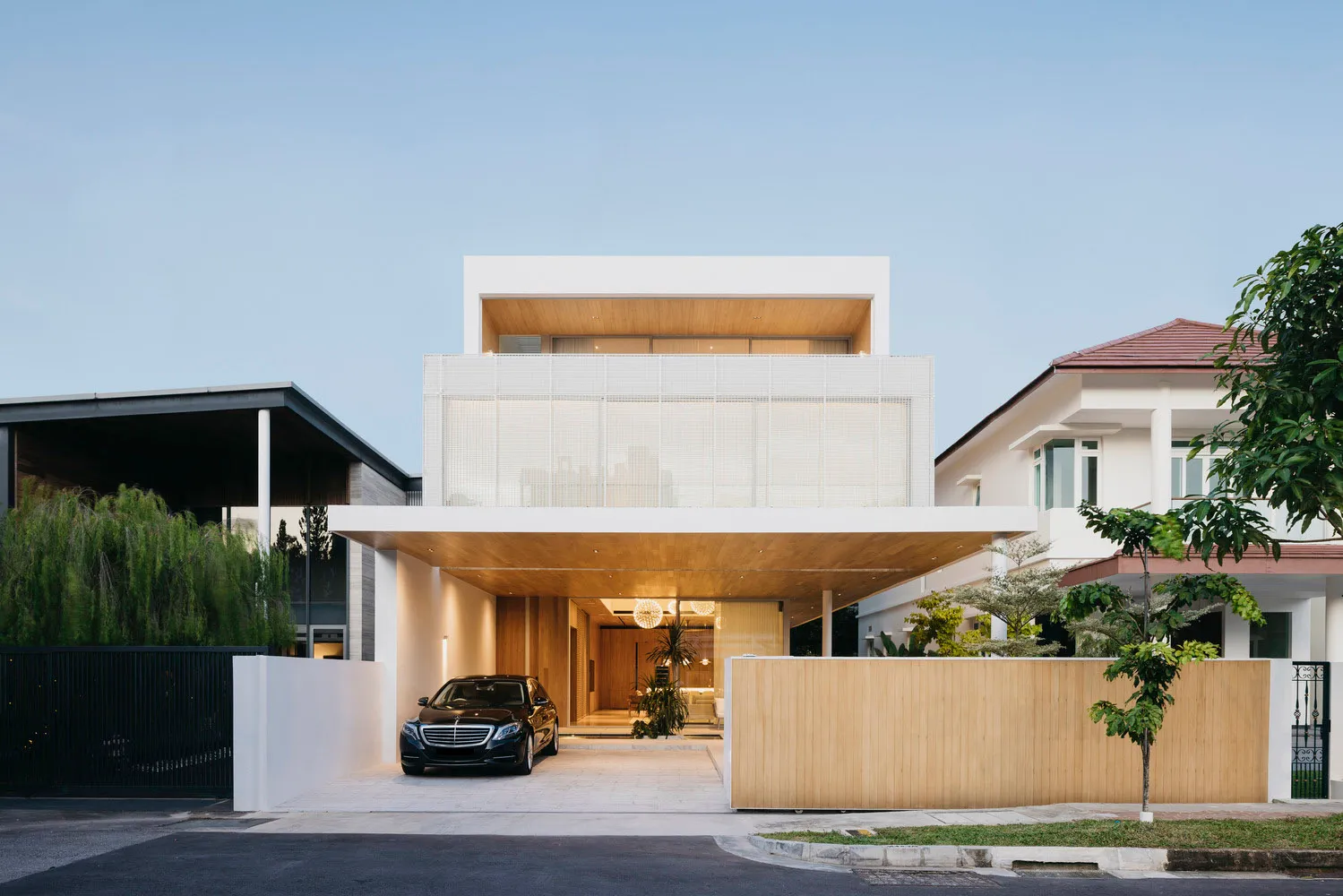 Modern residential house featuring wooden and glass exterior panels