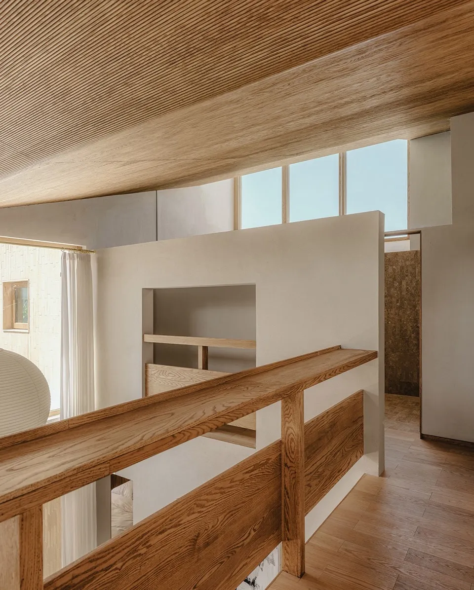 Modern minimalist loft interior with wooden railings and concrete walls