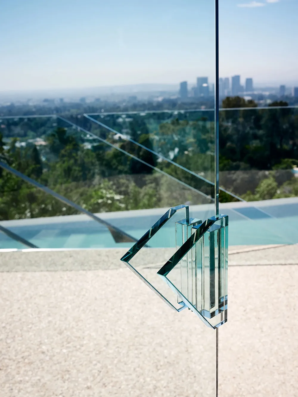 A modern glass exterior with a minimalistic design featuring glass panels and structural glass elements.