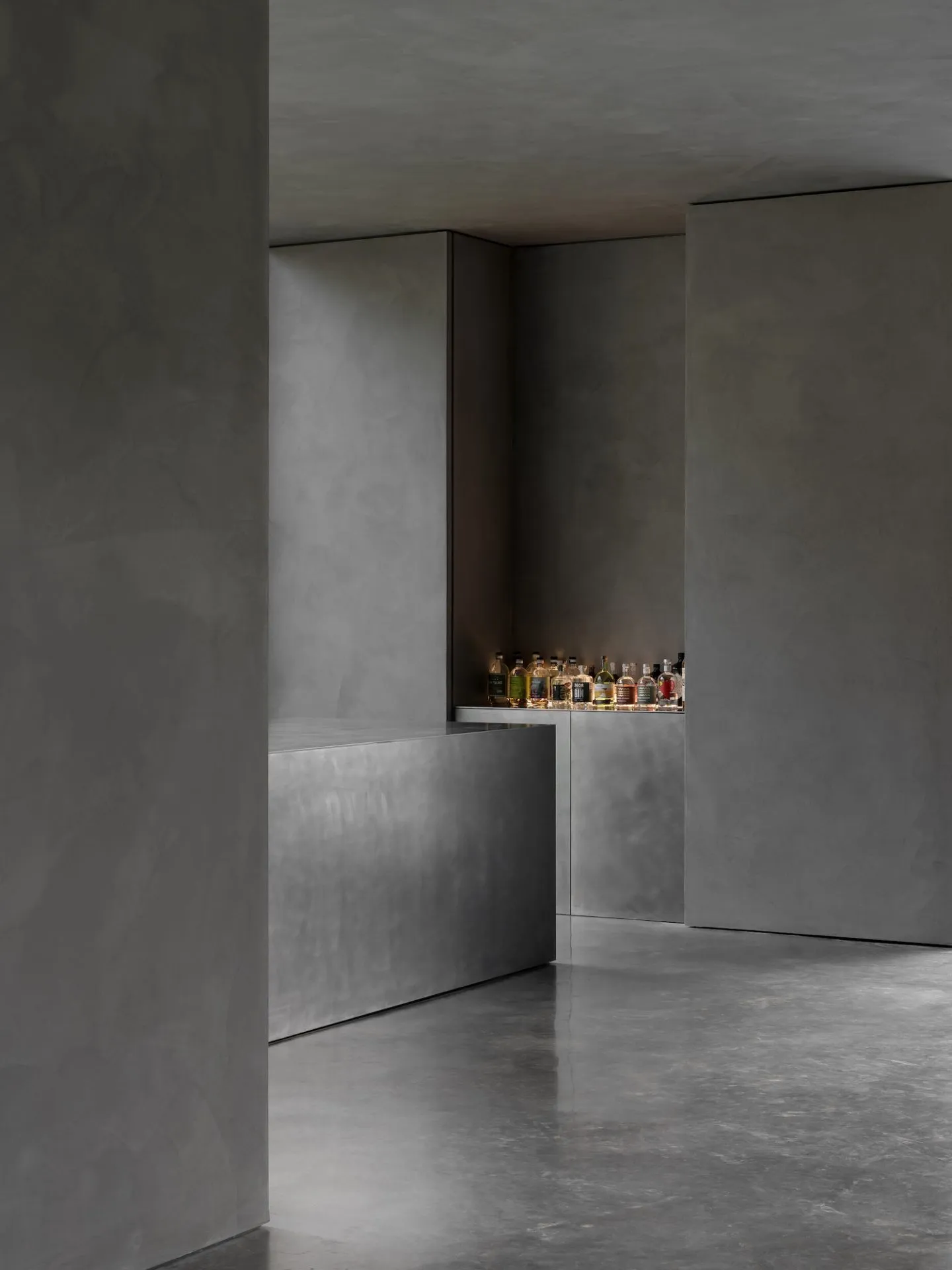 Modern industrial-style bar counter made of concrete, featuring a sleek design with a minimalist aesthetic.